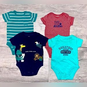 Four Carter’s baby boy onesies. Size 0-3/3 months.
